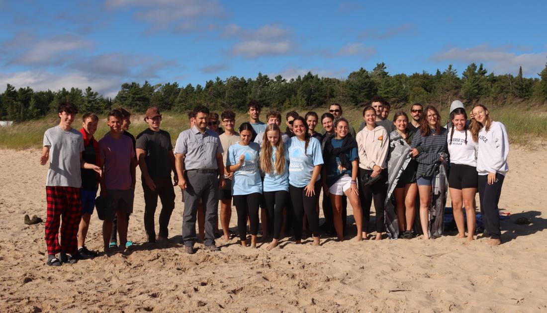 Young adults from the church gathered on the shore for a baptism in Lake Michigan